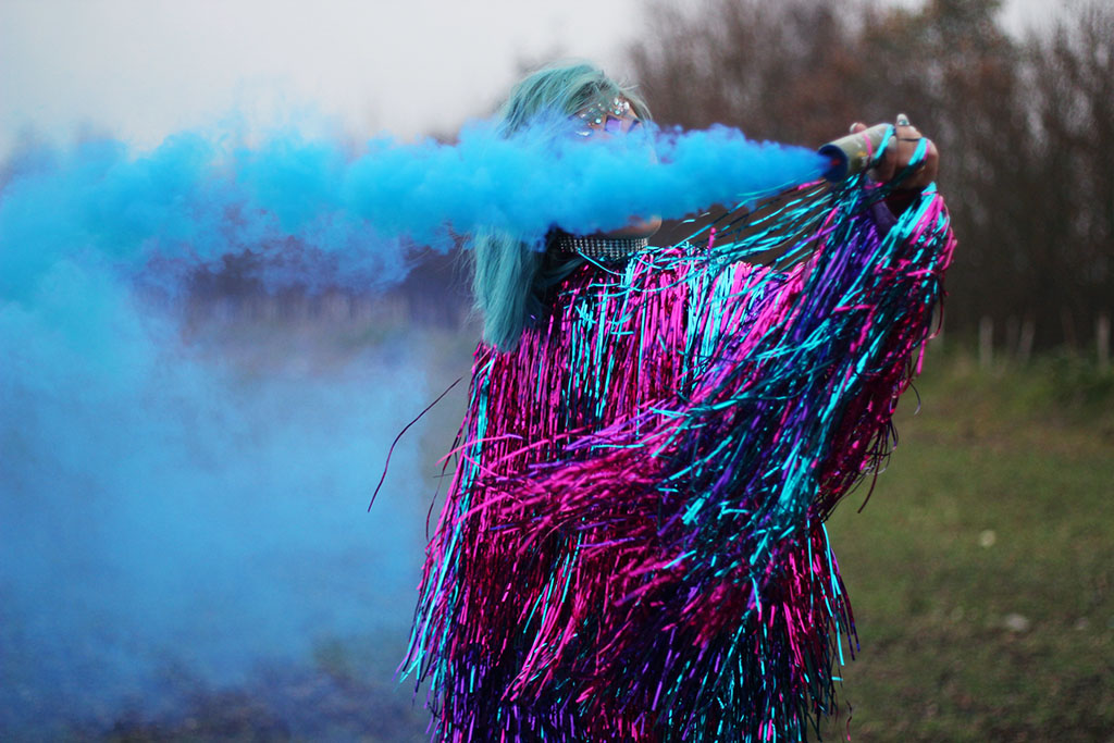 sophie hannah richardson with a smoke grenade celebrating new year goals